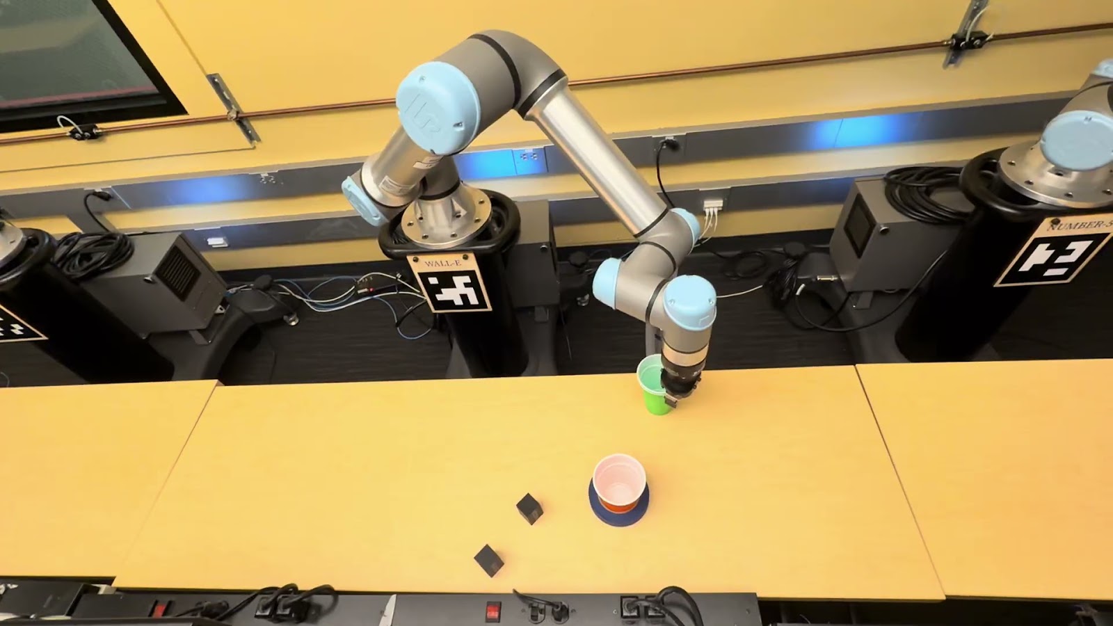 UR7e robotic arm gripping a green cup during the HECTUR demonstration